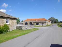Oblique view of adjacent outbuildings of Thorpe Farmhouse July 2016